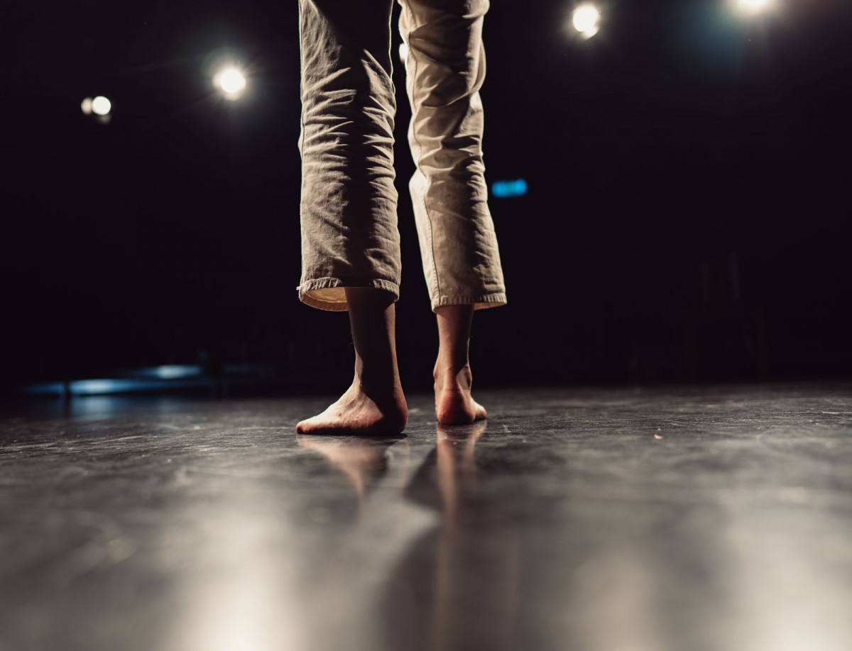 Schauspiel studentin Fenna steht barfuß auf der Probebühne.