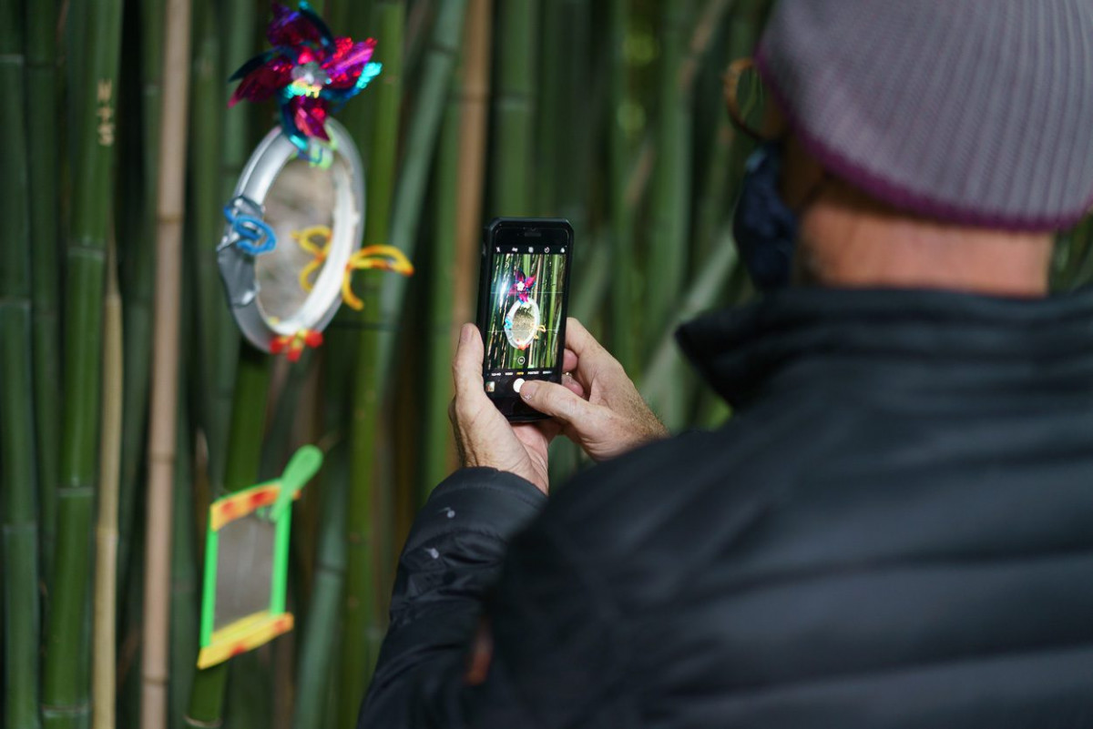 Ein junger Mann fotografiert ein Exponat mit seinem Smartphone.