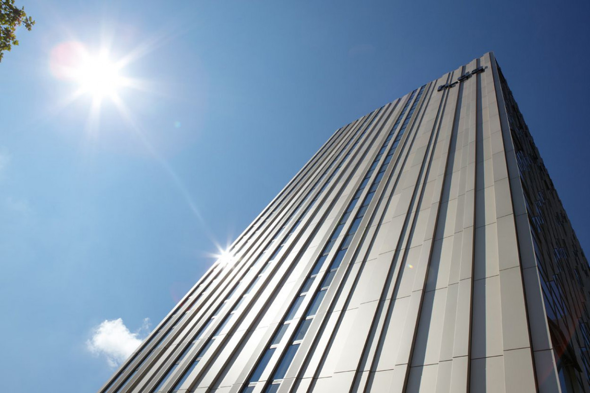 Fassade des Hauptgebäudes der Hochschule Darmstadt bei blauem Himmel und Sonnenschein